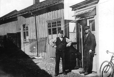 2 män stående framför byggnad
