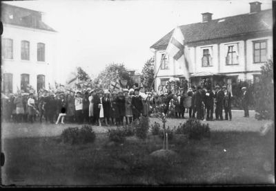 Ett antal personer stående på skolgård.
Nyckelord: Skola Flagga Skolbarn