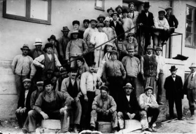 Ett antal män stående och sittande i trappa vid byggnad.
Nyckelord: Trappa Räcke Byggnad