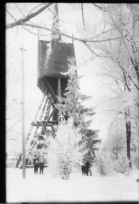 4 personer stående framför klockstapel.
Nyckelord: Vinter