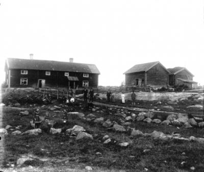 10 personer framför byggnad på landet
Nyckelord: Ladugård