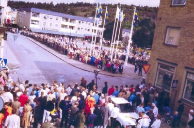 Folksamling längs gata
Nyckelord: TV-kamera;Bil