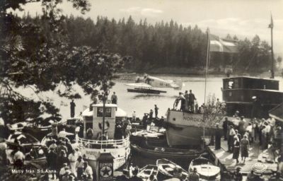 Båtar och många människor vid brygga
