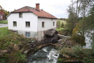 Stenbyggnad vid vattendrag
